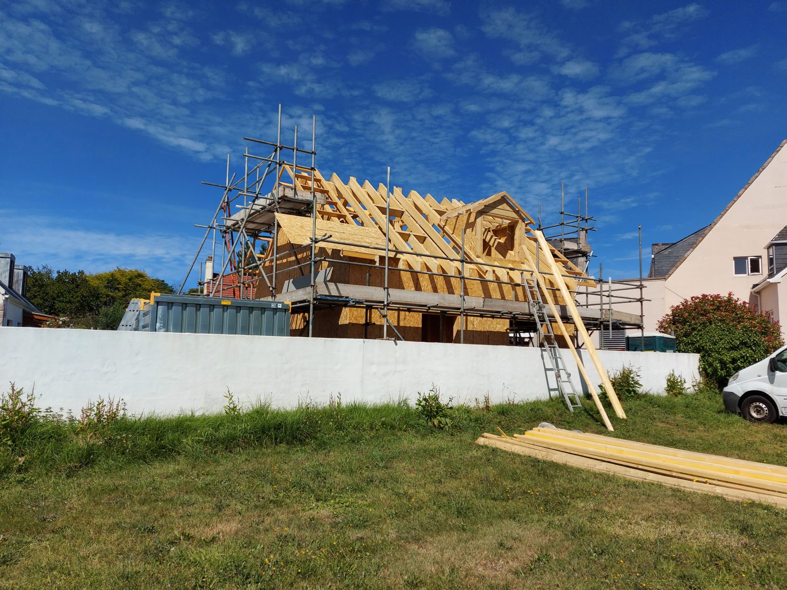 Roof framed out, scaffold wrapped: Timber frame new build project photo 13
